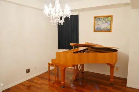 Studio Chez Claude（シェ・クロード）：シャンデリアのある部屋とグランドピアノ