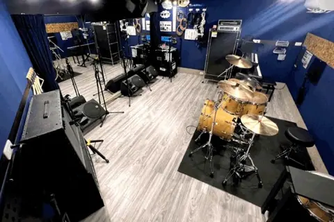 リフレクトスタジオ新栄店：ドラムセットとアンプのある室内